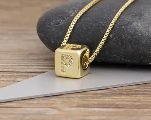 Detailed close-up of a gold-plated cubic alphabet letter P pendant necklace with sparkling zircons.