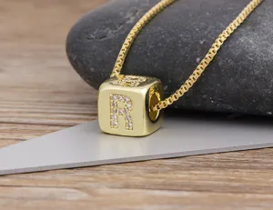Close-up detail of the elegant gold-plated cube letter R pendant necklace with zircon.