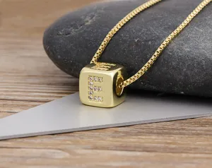 Gold plated cubic zirconia letter E cube pendant necklace detail showcasing refined craftsmanship.