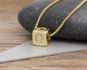 Close-up view of gold plated cubic zirconia alphabet letter O block pendant necklace for women.