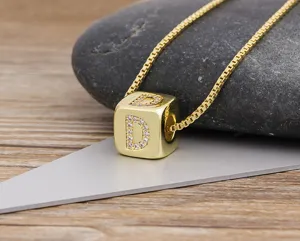 Gold plated letter D cube pendant necklace with sparkling zirconia stones close up detail