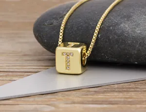 Gold plated letter T pendant necklace with sparkling cubic zirconia on cube charm for women.