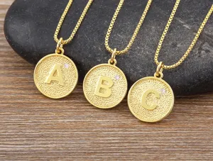 Gold plated initial letter pendant necklace detailed view featuring sparkling zircon stones.