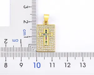 Detailed view of the gold rectangular cross pendant, featuring rhinestone pavé and colorful gems.