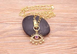 Primo piano dei dettagli del ciondolo per collana malocchio placcato in oro con zirconi squisiti.