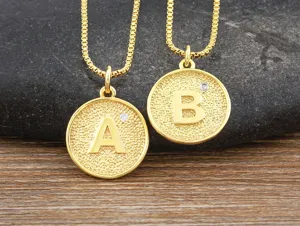 Gold plated brass alphabet letter pendant necklaces with sparkling zircon detail for women.