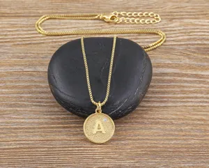 Close up view of gold plated initial letter pendant necklace with sparkling cubic zirconia detail.