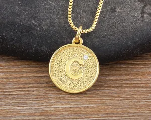 Close-up of a gold-plated letter C pendant necklace with a sparkling cubic zirconia stone detail.