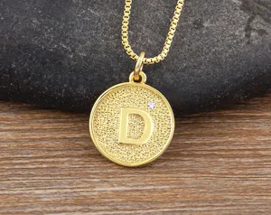 Gold plated brass pendant necklace featuring letter D charm and cubic zirconia detail.