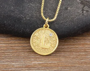 Gold-plated initial letter round pendant necklace with sparkling zircon detail, elegant jewelry design.