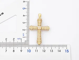 Gold cross pendant featuring sparkling cubic zirconia stones detailed dimension view
