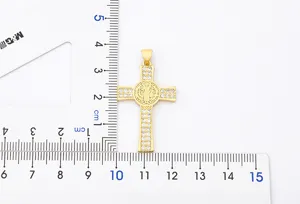 Detailed shot of gold plated cross pendant featuring sparkling zircons and delicate design.