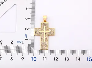 Gold plated cubic zirconia cross pendant jewelry detail shot showcasing product size and pave stones.
