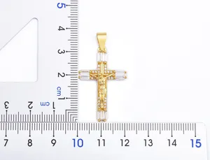 Gold cross pendant detail view with sparkly white cubic zirconia stones and crucifix design.