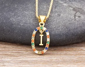 Close-up detail of a gold-plated multicolored cubic zirconia letter I pendant necklace.