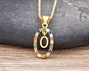 Gold-plated letter O pendant necklace with colorful cubic zirconia details, fine close-up view.