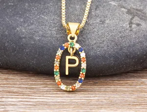Detailed view of gold color initial letter P pendant necklace with colorful cubic zirconia stones.
