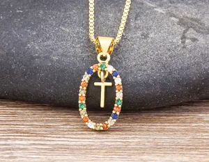 Detailed shot of a gold-plated necklace featuring a colorful zircon oval pendant with letter T.