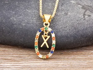 Gold-plated initial X necklace with colorful cubic zirconia stones pendant detail view.