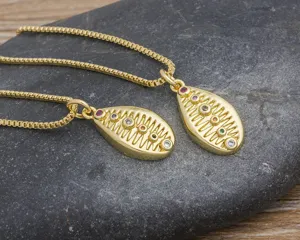 Detailed close-up of a fashionable gold-plated shell pendant necklace with multi-color zircons.