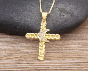 Detailed closeup of gold plated cross pendant necklace with sparkling cubic zirconia moon.
