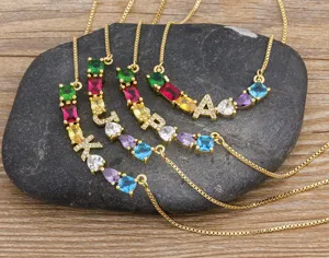 Gold plated alphabet necklace with colorful cubic zirconia stones and adjustable chain.