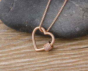 Collier pendentif mousqueton cœur en or rose avec micro strass brillants et chaîne fine.