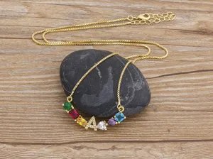 Elegant gold-plated copper necklace featuring multi-color cubic zirconia and letter pendant.