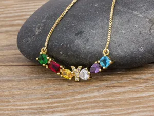 Detailed close-up view of the colorful gemstone alphabet pendant necklace with micro-paved zircons.