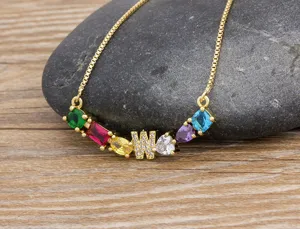 Gold-plated brass necklace featuring multicolored cubic zirconia stones and a pave letter W pendant.