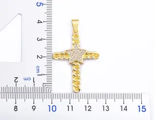Gold cross pendant close-up, featuring a paved star center and twisted chain texture.