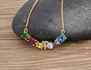 Detailed view of gold-plated initial letter T necklace with colorful cubic zirconia charms.
