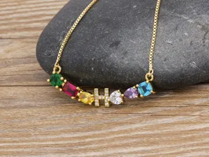 Detailed shot of the gold-plated alphabet necklace featuring colorful cubic zirconia and letter H pendant.