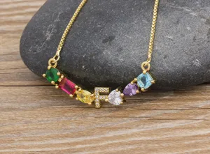 Detailed view of gold-plated alphabet necklace with colorful cubic zirconia and letter F charm.