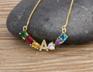 Gold plated box chain necklace featuring a pavé zircon letter A and colorful gemstone charms.
