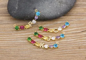 Detailed shot of gold plated brass colorful cubic zirconia initial letter pendant connectors for DIY jewelry.