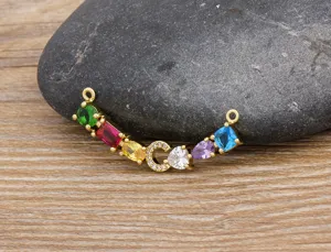 Detailed shot of a gorgeous gold-plated colorful zircon letter C necklace pendant connector.