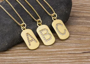 Gold paved initial letter tag pendant necklace, sparkling cubic zirconia jewelry detail.
