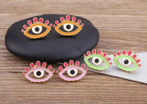 Close-up of colorful enamel evil eye stud earrings with 18k gold plated copper design.