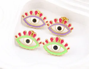 Evil eye stud earrings, copper plated gold with colorful enamel, trendy fashion jewelry detail.
