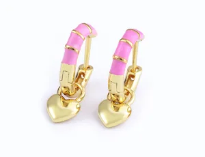 Detailed view of gold plated heart enamel hoop earrings, sweet pink striped drop fashion jewelry.