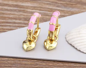 Exquisite pink enamel heart hoop earrings in gold tone, detailed texture for daily wear.