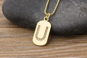 Gold initial letter U pendant necklace with sparkling cubic zirconia on a chic box chain.