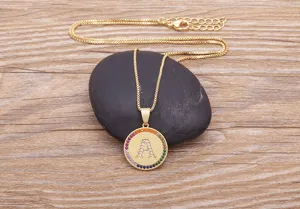 Detailed shot of gold-plated copper letter A pendant necklace with colorful cubic zirconia.
