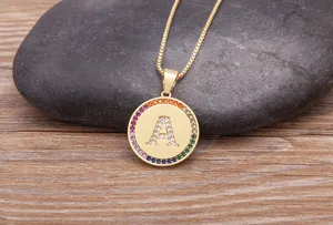 Gold-plated brass alphabet necklace with sparkling rainbow cubic zirconia round letter A pendant.