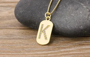 Detailed view of a gold initial K pendant necklace sparkling with cubic zirconia stones on chain.