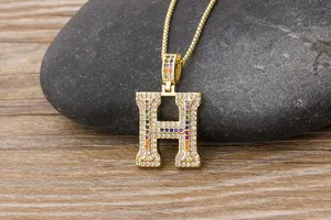 Gold-plated iced out initial H pendant necklace with colorful cubic zirconia for hip hop fashion.