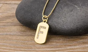 Close-up of gold-plated rectangular letter F pendant necklace with dazzling cubic zirconia.