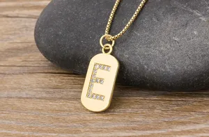 Close-up detail of the elegant gold-plated letter E initial pendant necklace with sparkling zirconia.