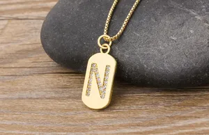 Detailed view of gold-plated initial N pendant necklace with sparkling cubic zirconia stones.